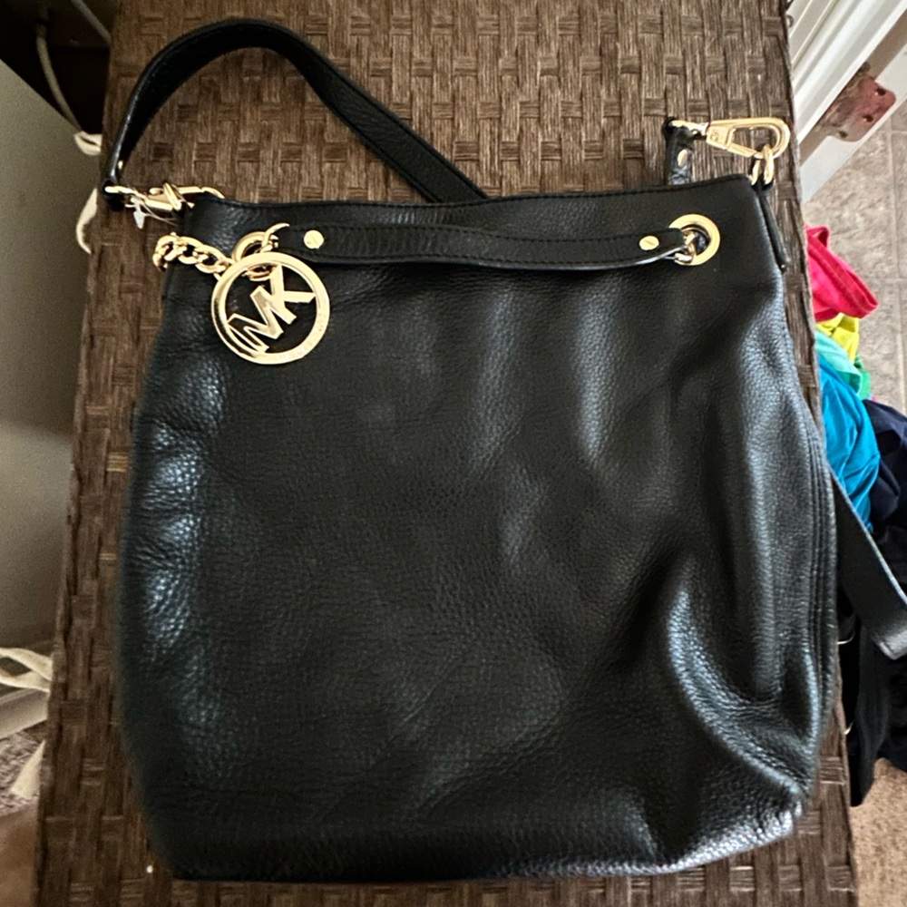 Black Michael Kors bag with handles and shoulder strap. Not a crossbody.